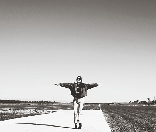 Man standing on field against clear sky