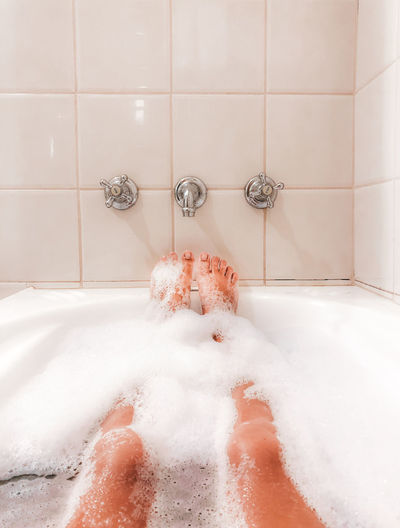 Woman relaxing  in bubble bath at home