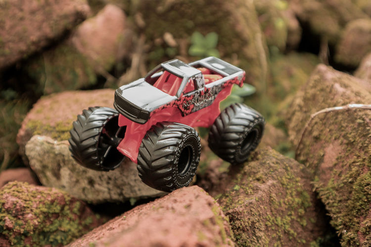 Close-up of tough toy car on difficult terrain