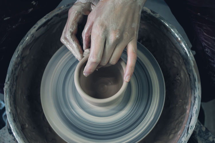 Creating ceramic products of white clay close-up. the sculptor in workshop makes clay jug closeup. 