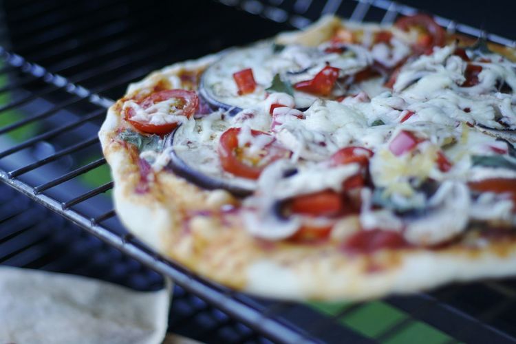 Close-up of pizza on cooling rack