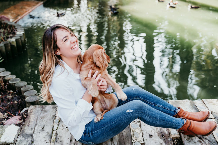 Young woman with dog on water
