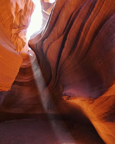 Low angle view of rock formations at lower antelope canyon during sunny day