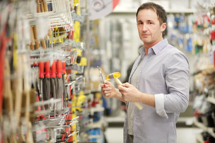 Portrait of man standing at hardware store