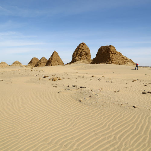 View of sand dunes in desert against sky