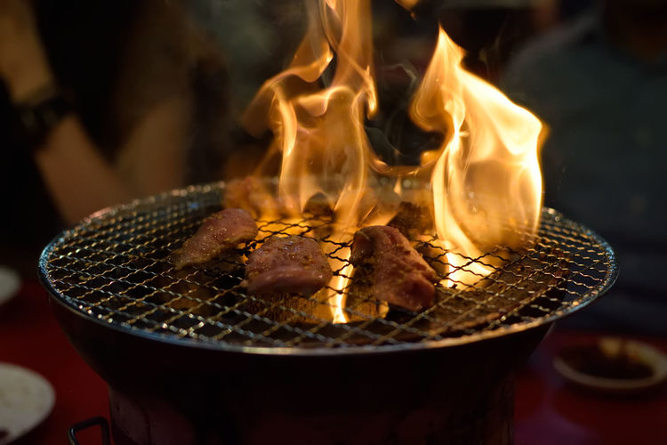 Close-up of burning candles on barbecue