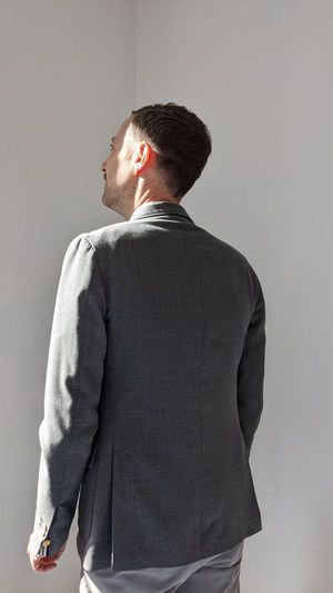 Young man standing against white background