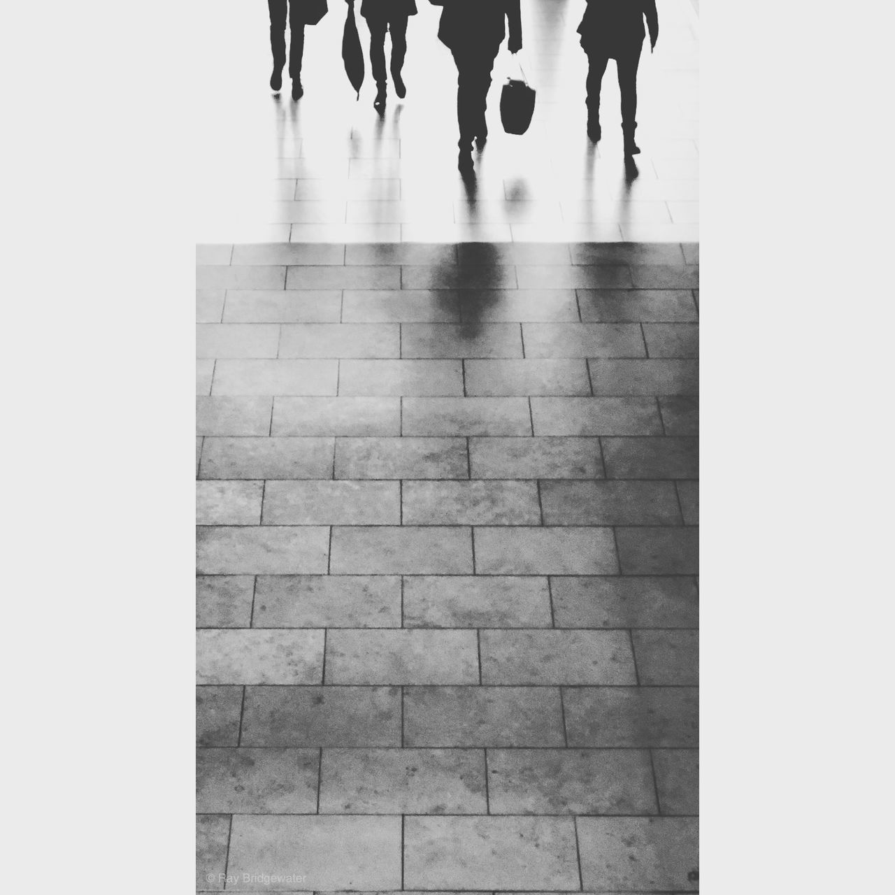 LOW SECTION OF PEOPLE WALKING ON FLOORING