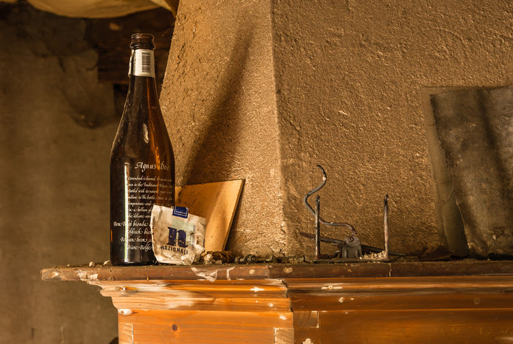 Old wine bottle by wall