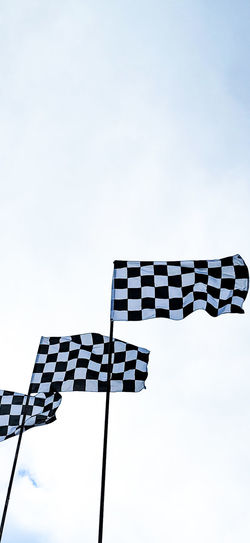 Low angle view of flags against sky
