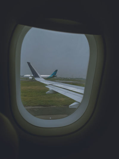 Airplane flying seen through window