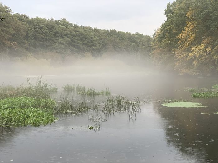 Scenic view of lake against sky during rainy season