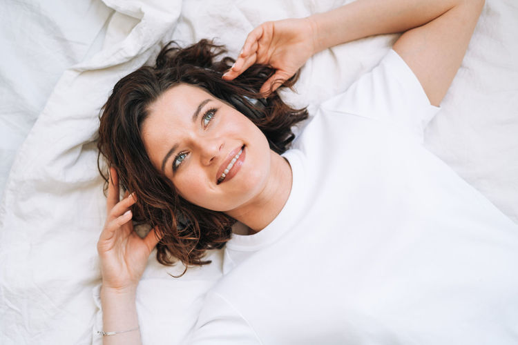 Portrait of young woman sleeping on bed