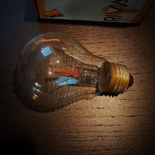 High angle view of illuminated light bulb on table