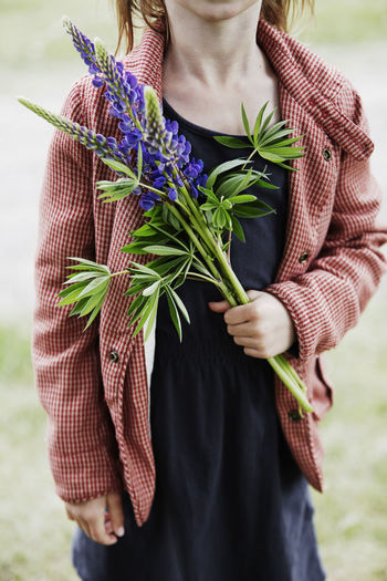 Girl holding lupine flower