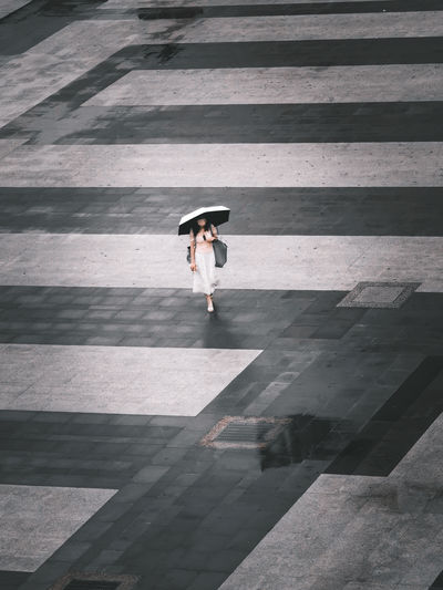 High angle view of a woman walking on the street.