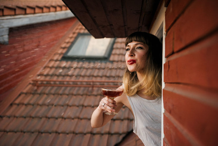 Woman spitting drink at window