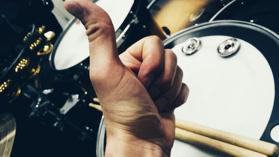 Close-up of drummer showing thumbs up sign
