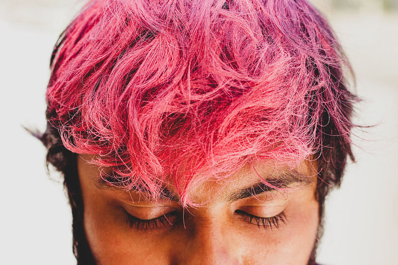 Close-up of man with pink hair