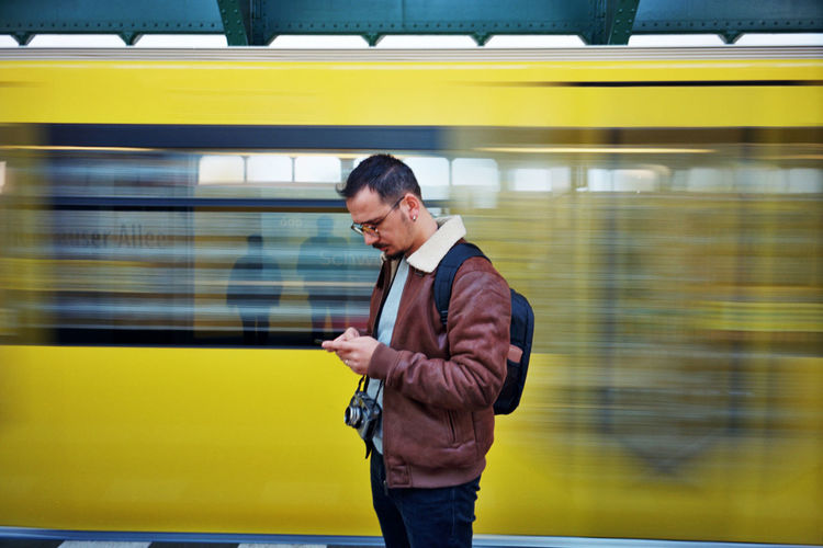 Full length of man standing on train