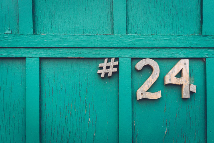 Close-up of number 24 on closed door