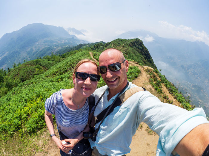 Portrait of couple standing on mountain range