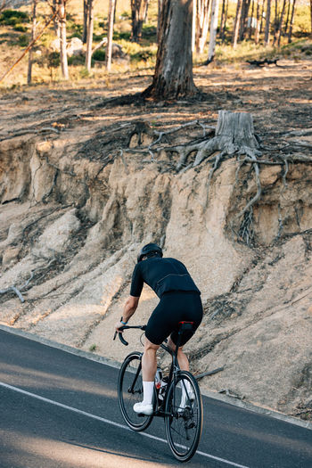 Man riding bicycle on road