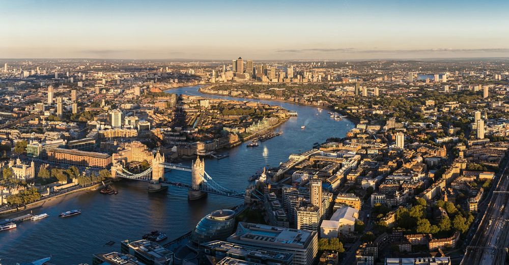 Tower bridge over thames river with cityscape against sky