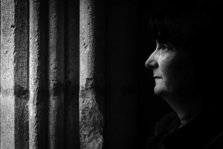 Woman looking away in darkroom
