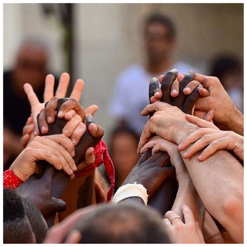 Diverse people holding hands representing unity
