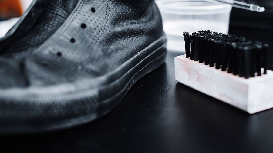 Close-up of shoe with cleaning brush