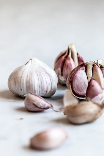Close-up of garlic on table against white background