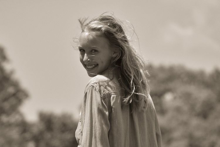 Portrait of smiling girl standing outdoors