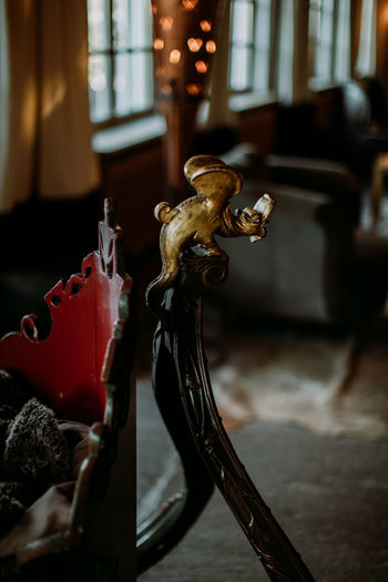 Close-up of sculpture on table by window