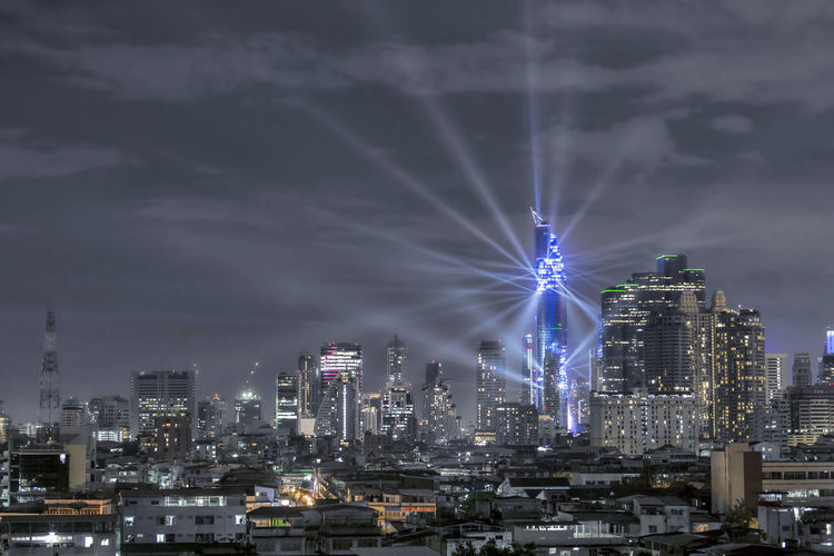 Illuminated mahanakhon tower in city against sky at night