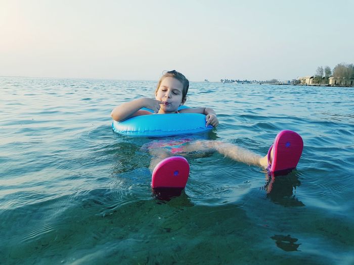 Girl with inflatable ring in sea