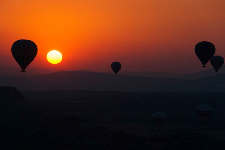 Silhouette of hot air balloon against sky during sunset