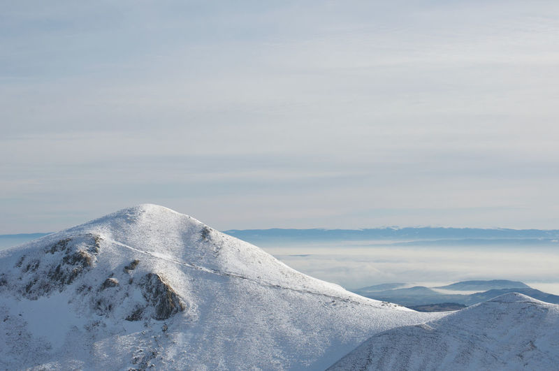 Scenic view of snowcapped mont sancy mountain against sky in auvergne france