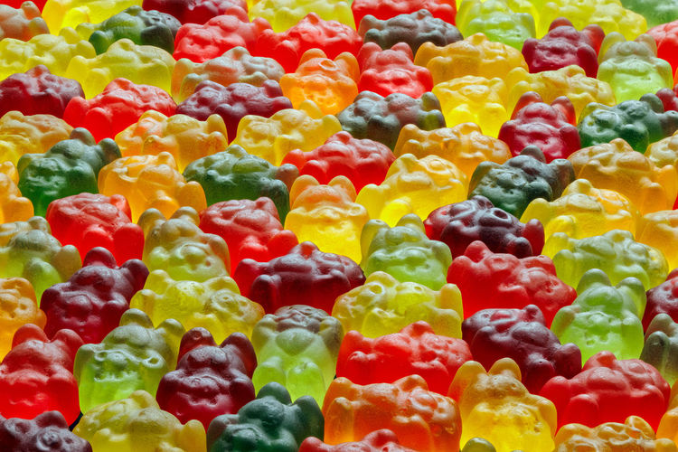 Full-frame background of colorful jelly bears laid closely on flat surface