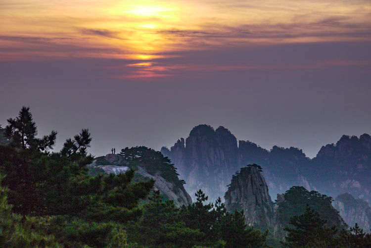 Scenic view of mountains against sky at sunset