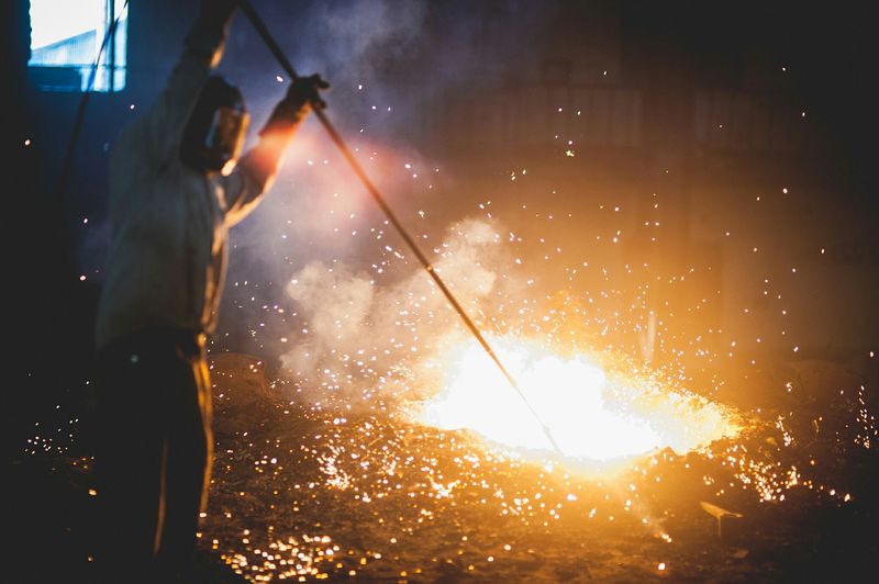 Man melting iron at factory
