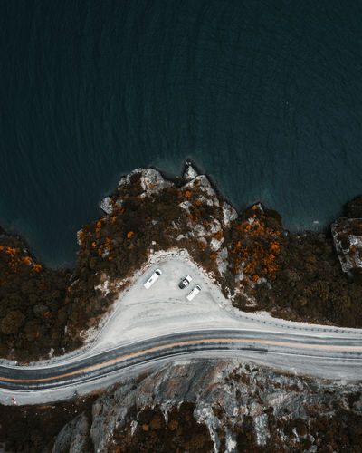 High angle view of road by sea against mountain