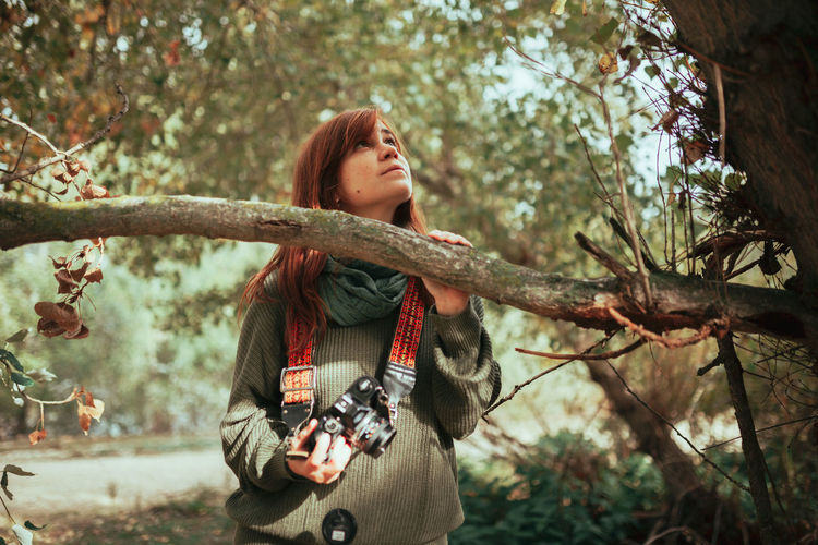 Close-up of woman standing by tree