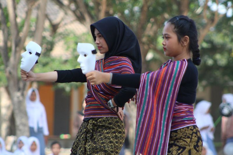 A woman is demonstrating a traditional dance