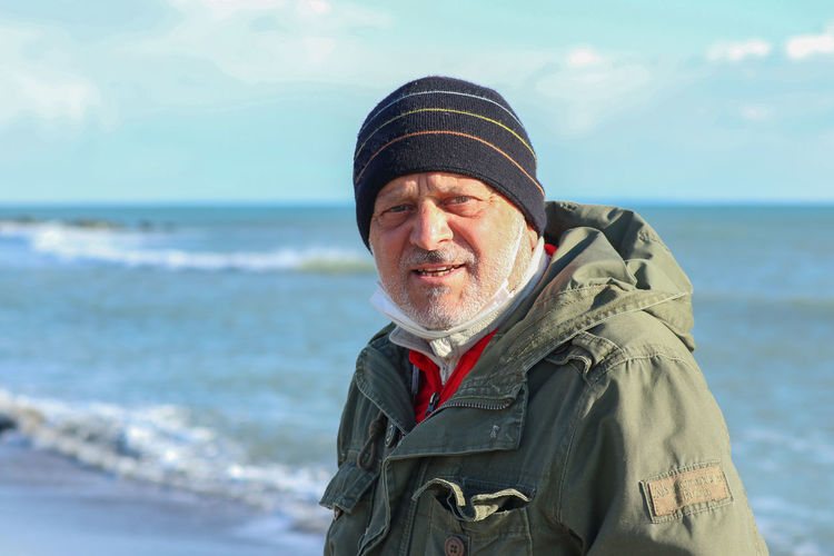Portrait of man wearing hat on beach
