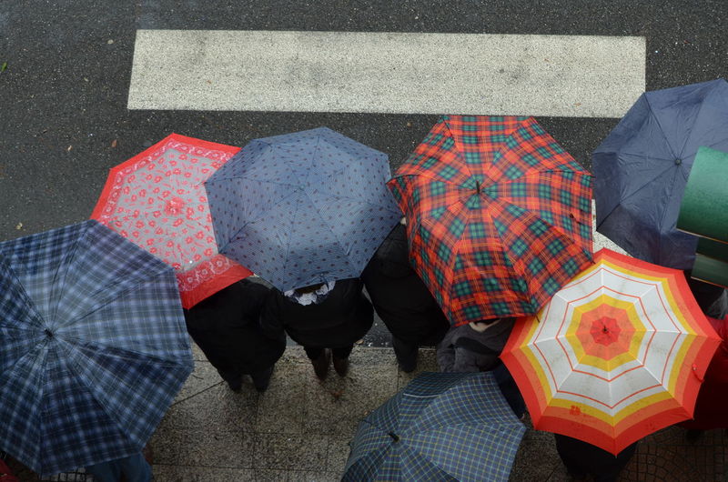 High angle view of people with umbrellas on road
