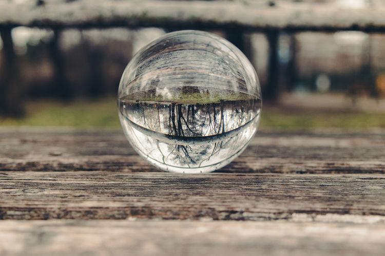 Close-up of crystal ball on wooden surface