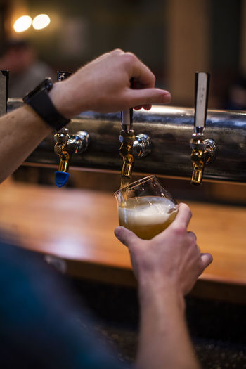 A man pours a beer at a brewery in the dalles, oregon.