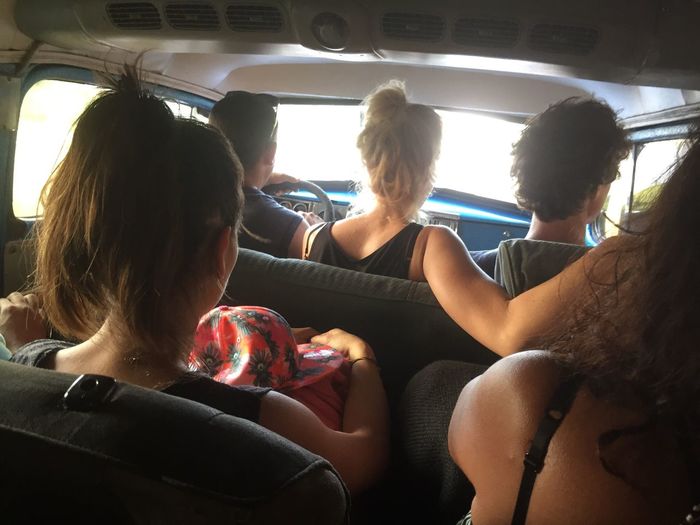 Rear view of women sitting in car
