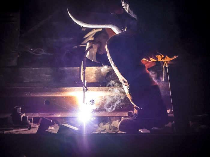 Man welding at night